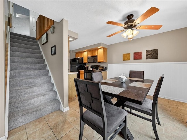 54 Flower Dale Cir, Greece, NY 14626 - dining space with stairway, ceiling fan, wainscoting, and light tile patterned floors
