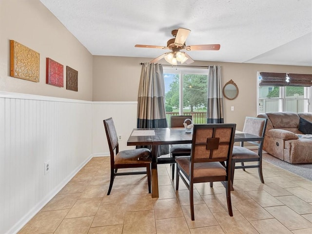 54 Flower Dale Cir, Greece, NY 14626 - dining room with healthy amount of natural light, a wainscoted wall, a textured ceiling, and ceiling fan