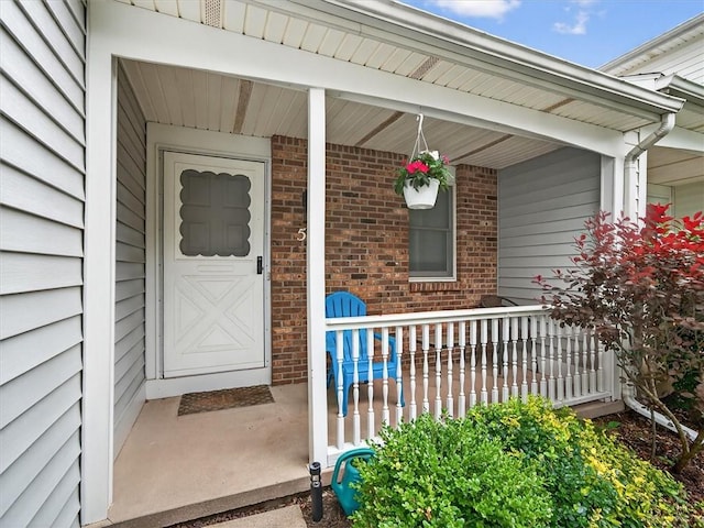 54 Flower Dale Cir, Greece, NY 14626 - view of exterior entry featuring covered porch and brick siding
