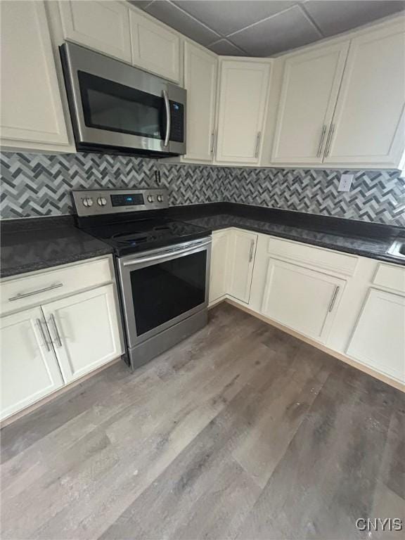 24 Elm St, Whitestown, NY 13492 - kitchen featuring stainless steel appliances, dark countertops, tasteful backsplash, and dark wood-style flooring