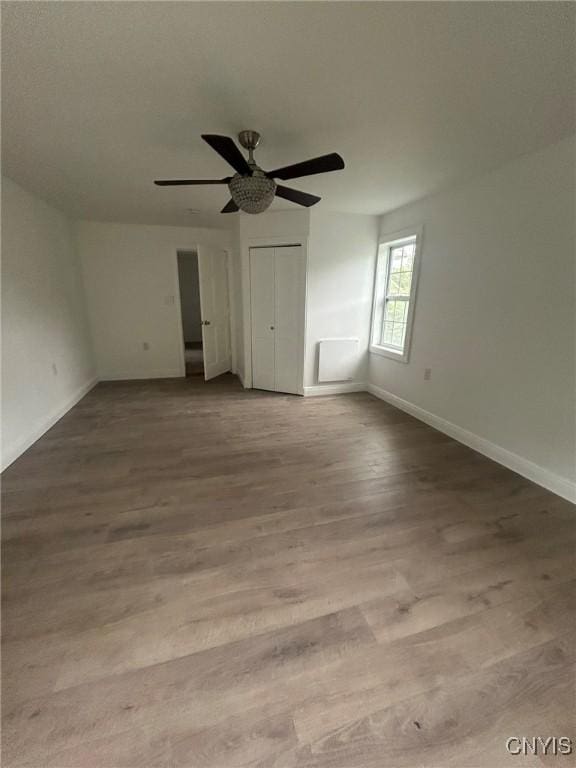 24 Elm St, Whitestown, NY 13492 - unfurnished bedroom with wood finished floors and ceiling fan