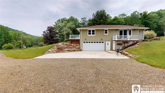 12483 Sawmill Run Rd, South Valley, NY 14738 - view of front of home with driveway, a garage, stairway, a front yard, and stucco siding