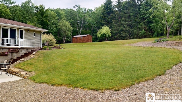 12483 Sawmill Run Rd, South Valley, NY 14738 - view of grassy yard featuring a storage shed, stairway, and a patio area