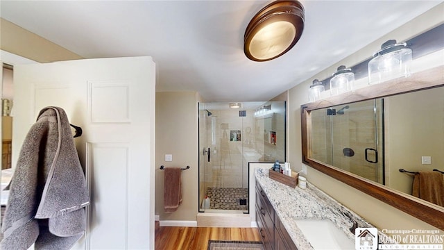 12483 Sawmill Run Rd, South Valley, NY 14738 - bathroom with a shower stall, vanity, and wood finished floors