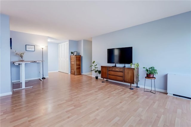 1400 E Ave Unit Un609, Rochester, NY 14610 - living area with light wood-style flooring and baseboards
