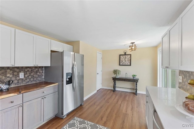 4302 Cinnamon Path, Clay, NY 13090 - kitchen featuring appliances with stainless steel finishes, backsplash, light wood-style flooring, and white cabinets