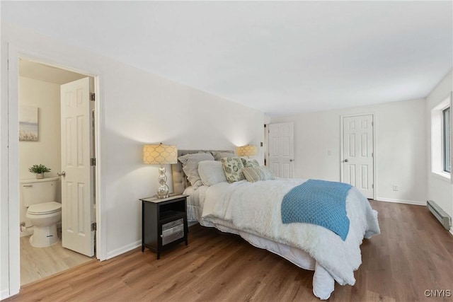 4302 Cinnamon Path, Clay, NY 13090 - bedroom with wood finished floors, ensuite bathroom, baseboard heating, and a closet