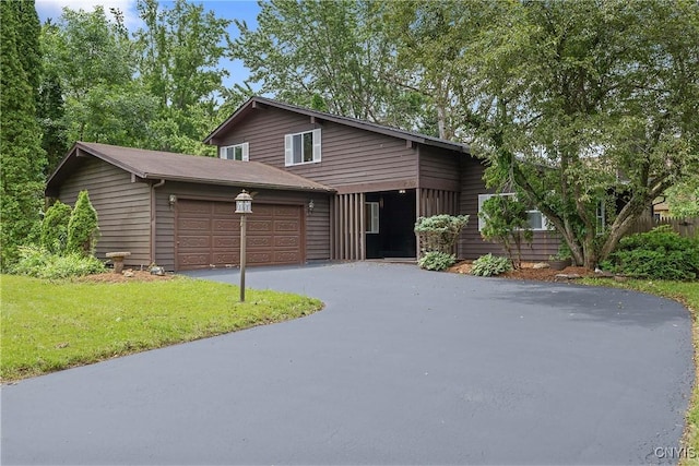4302 Cinnamon Path, Clay, NY 13090 - view of front of house featuring an attached garage, asphalt driveway, and a front lawn