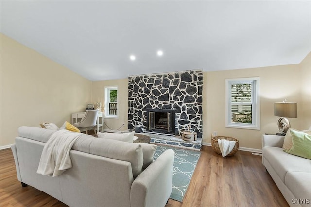 4302 Cinnamon Path, Clay, NY 13090 - living room with healthy amount of natural light, wood finished floors, a fireplace, lofted ceiling, and recessed lighting