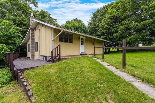 2361 E Hill Rd, Preble, NY 13077 - view of front of house with entry steps, a wooden deck, a front yard, and a chimney