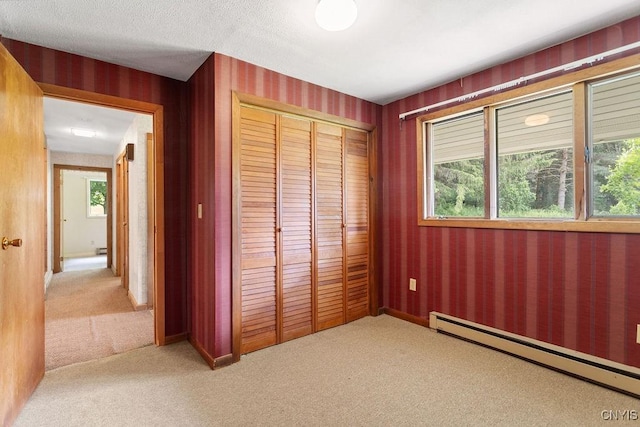 2361 E Hill Rd, Preble, NY 13077 - unfurnished bedroom featuring a baseboard radiator, light colored carpet, and a closet