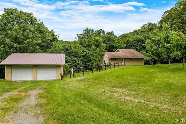 2361 E Hill Rd, Preble, NY 13077 - view of yard featuring a garage, an outdoor structure, driveway, and a view of trees