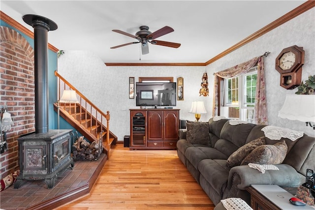 5107 County Road 36, Richmond, NY 14471 - living room with light wood-type flooring, a wood stove, ceiling fan, crown molding, and wallpapered walls