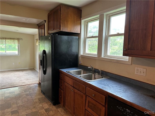8362 Price Rd, Floyd, NY 13354 - kitchen with black appliances, brown cabinets, and light colored carpet