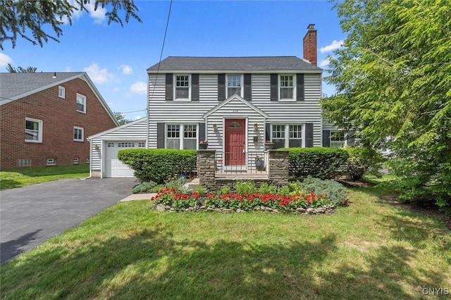 312 S Orchard Rd, Geddes, NY 13219 - colonial inspired home featuring a chimney, driveway, a front lawn, and an attached garage