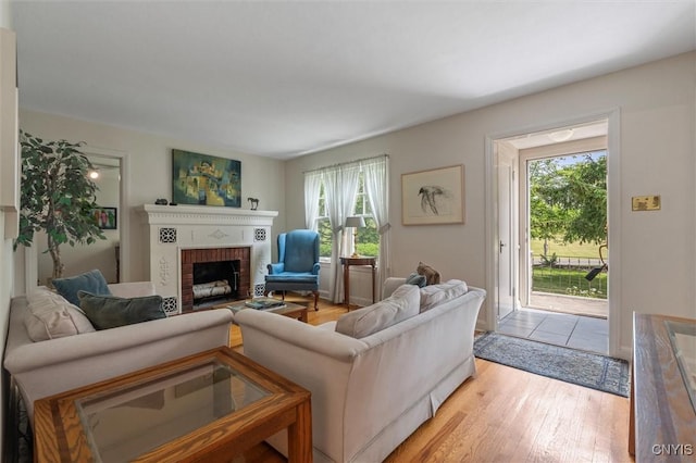312 S Orchard Rd, Geddes, NY 13219 - living area with plenty of natural light, a fireplace, and light wood-style flooring