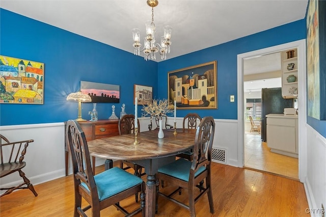 312 S Orchard Rd, Geddes, NY 13219 - dining space with wood finished floors and a chandelier