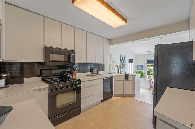 312 S Orchard Rd, Geddes, NY 13219 - kitchen with black appliances, light countertops, tasteful backsplash, vaulted ceiling, and light flooring