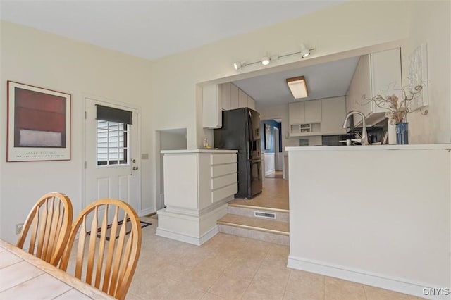 312 S Orchard Rd, Geddes, NY 13219 - kitchen with black refrigerator with ice dispenser and light tile patterned flooring