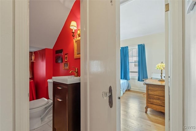 312 S Orchard Rd, Geddes, NY 13219 - ensuite bathroom with vanity, wood finished floors, and vaulted ceiling
