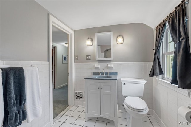 312 S Orchard Rd, Geddes, NY 13219 - bathroom featuring tile walls, tile patterned flooring, vanity, and a wainscoted wall