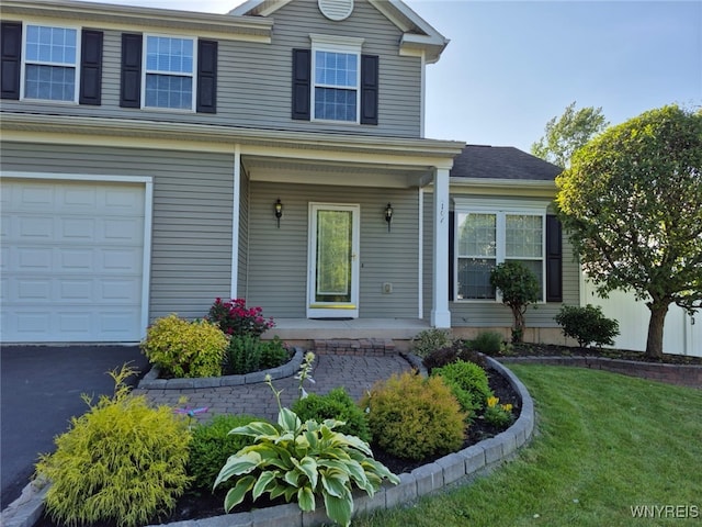 107 Naymik Dr, Sullivan, NY 13037 - view of front of home with covered porch, a front lawn, and an attached garage