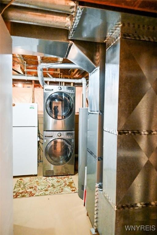 107 Naymik Dr, Sullivan, NY 13037 - unfinished basement featuring freestanding refrigerator, stacked washer / drying machine, and heating unit