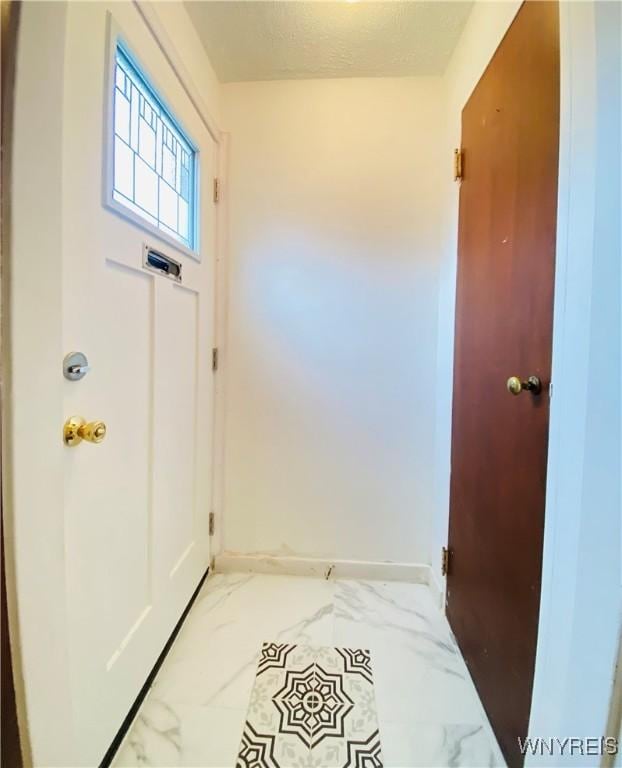 23 Bennett Village Ter, Buffalo, NY 14214 - doorway to outside with light marble finish flooring and baseboards