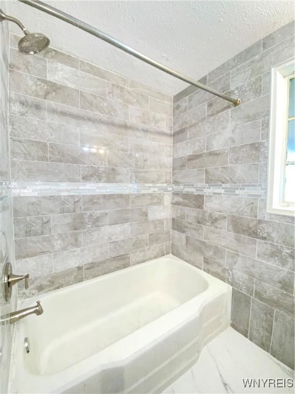 23 Bennett Village Ter, Buffalo, NY 14214 - full bath with tile walls, shower / washtub combination, and a textured ceiling