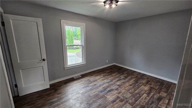 726 S Main St, Shelby, NY 14103 - empty room featuring dark wood-style floors and baseboards