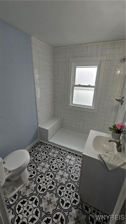 726 S Main St, Shelby, NY 14103 - bathroom with tile patterned flooring, a tile shower, and vanity