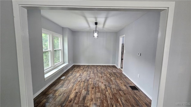 726 S Main St, Shelby, NY 14103 - unfurnished dining area featuring dark wood-style flooring and baseboards