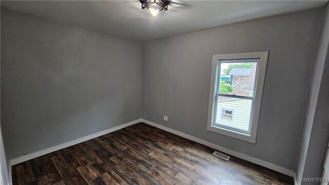 726 S Main St, Shelby, NY 14103 - unfurnished room with dark wood-type flooring and baseboards