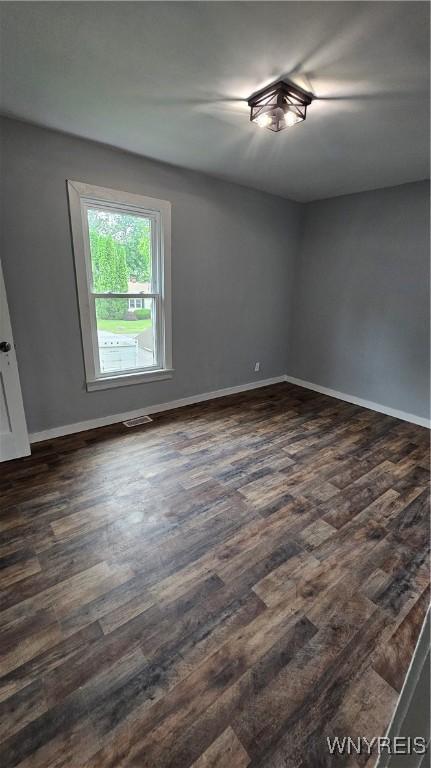 726 S Main St, Shelby, NY 14103 - unfurnished room featuring dark wood-style floors and baseboards