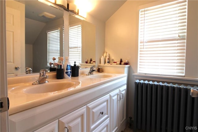 218 S Terry Rd, Geddes, NY 13219 - bathroom featuring radiator heating unit, lofted ceiling, and double vanity