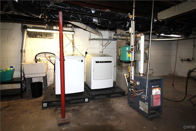 218 S Terry Rd, Geddes, NY 13219 - unfinished below grade area featuring washer and dryer and a heating unit