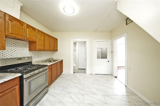50 Avery Pl, Cheektowaga, NY 14225 - kitchen with stainless steel gas range, light marble finish floors, tasteful backsplash, and brown cabinets