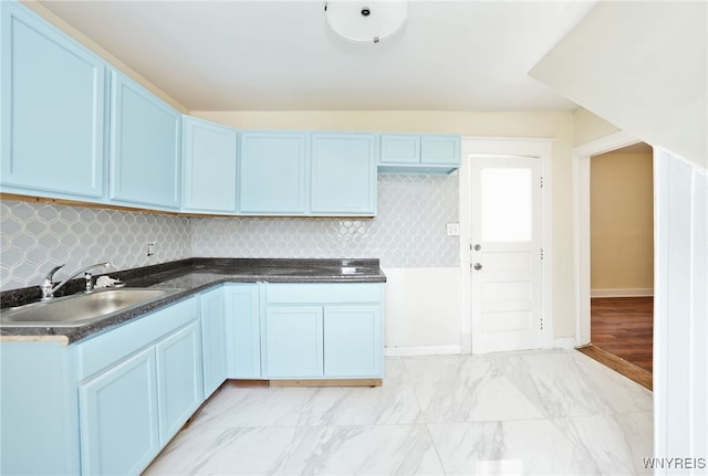 50 Avery Pl, Cheektowaga, NY 14225 - kitchen featuring dark countertops, tasteful backsplash, light marble finish floors, and blue cabinetry