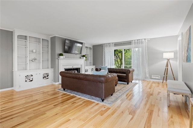 100 Carverdale Dr, Brighton, NY 14618 - living area featuring wood finished floors, a fireplace, and built in features