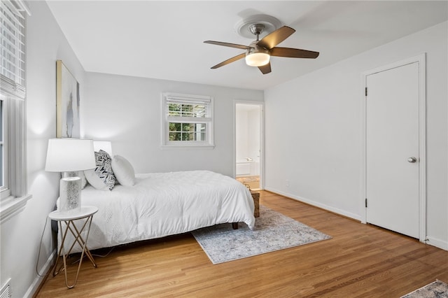 100 Carverdale Dr, Brighton, NY 14618 - bedroom with wood finished floors, ensuite bathroom, and a ceiling fan