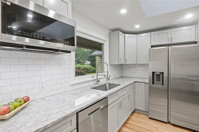 100 Carverdale Dr, Brighton, NY 14618 - kitchen with stainless steel appliances, tasteful backsplash, recessed lighting, and light stone countertops