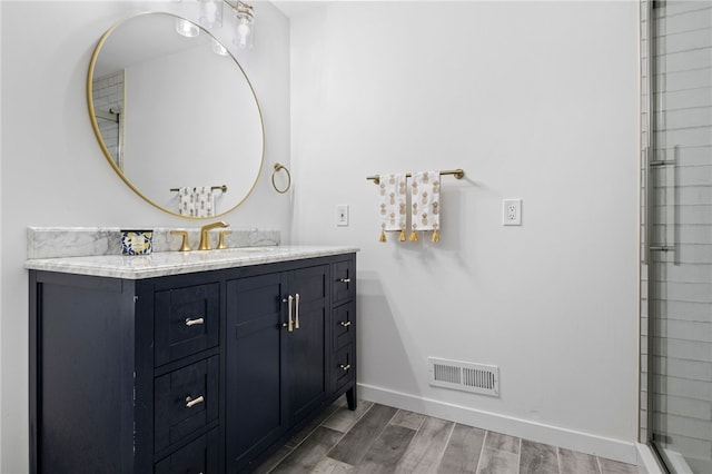 100 Carverdale Dr, Brighton, NY 14618 - full bathroom featuring vanity, wood finished floors, and a shower with shower door