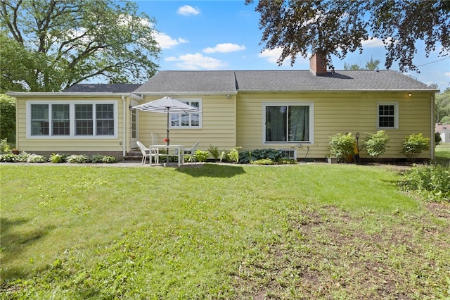 100 Carverdale Dr, Brighton, NY 14618 - back of house featuring a chimney, a yard, and a patio