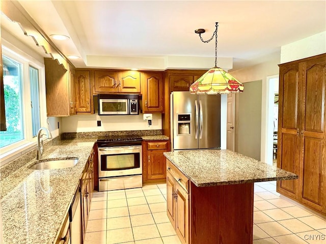 1000 Sherman Dr, Utica, NY 13501 - kitchen featuring stainless steel appliances, light tile patterned flooring, brown cabinets, and light stone counters
