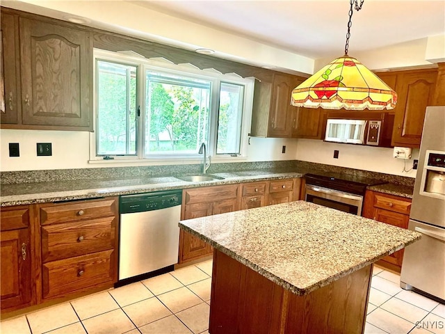 1000 Sherman Dr, Utica, NY 13501 - kitchen featuring stainless steel dishwasher, fridge with ice dispenser, light tile patterned floors, pendant lighting, and a center island
