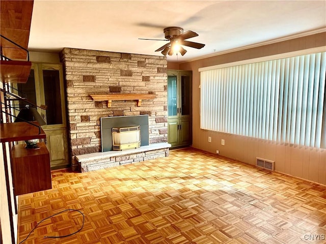 1000 Sherman Dr, Utica, NY 13501 - unfurnished living room featuring ceiling fan, a fireplace, stairs, and wooden walls