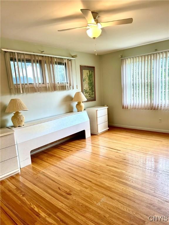 1000 Sherman Dr, Utica, NY 13501 - bedroom featuring wood finished floors and a ceiling fan