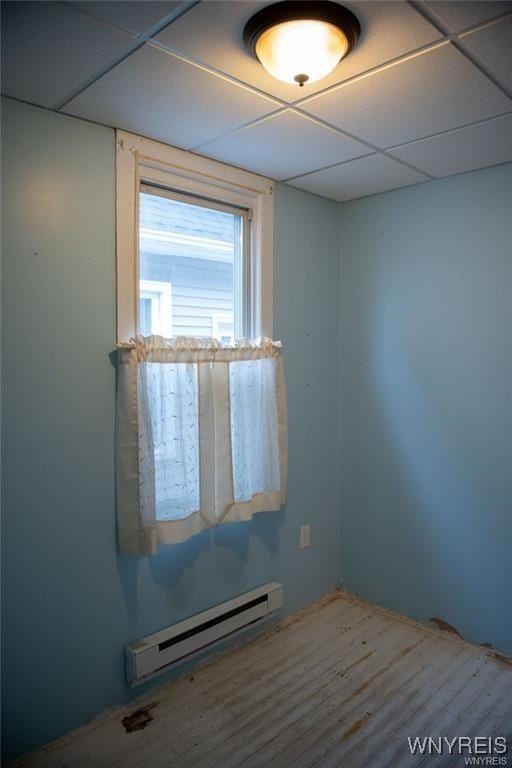150 Weiss St, Buffalo, NY 14206 - spare room with baseboard heating, a paneled ceiling, and wood finished floors