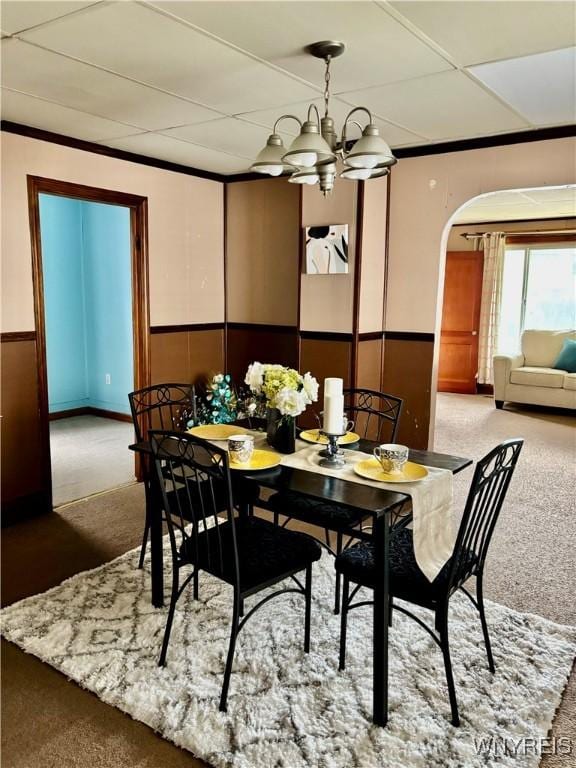150 Weiss St, Buffalo, NY 14206 - carpeted dining room with arched walkways, wainscoting, a chandelier, and a paneled ceiling