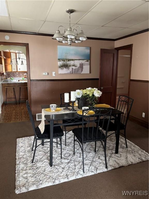 150 Weiss St, Buffalo, NY 14206 - dining space featuring a chandelier, dark colored carpet, and a paneled ceiling